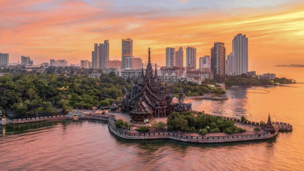 Sanctuary of Truth with Pattaya skyline at sunset