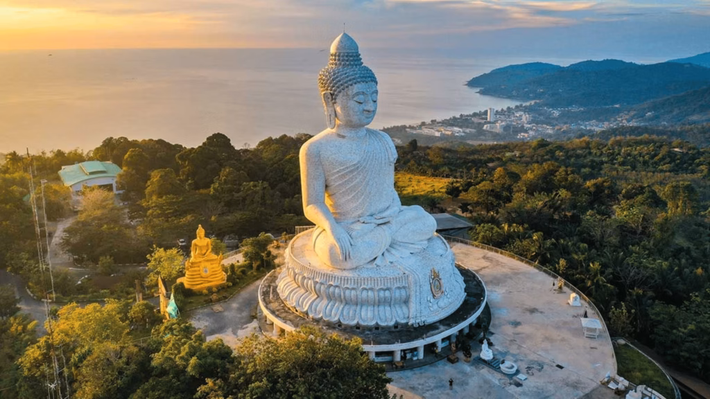 Big Buddha overlooking Phuket's coastline at sunset